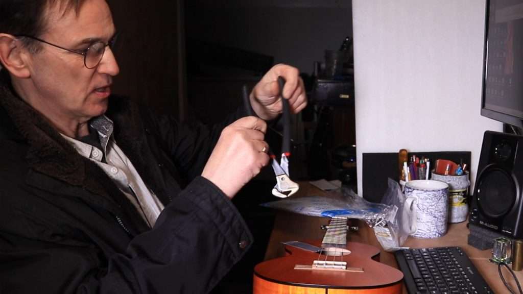 Getting ready with pincers to pull frets from a Ukulele