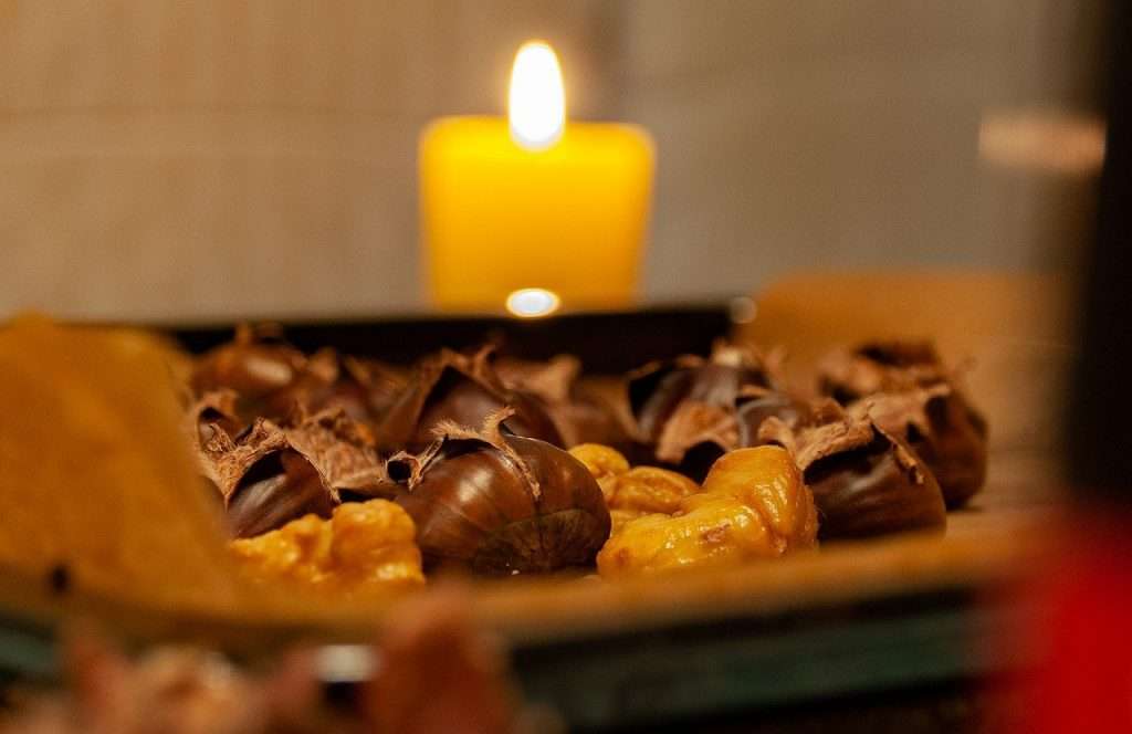 Chestnuts on a plate in front of an open candle